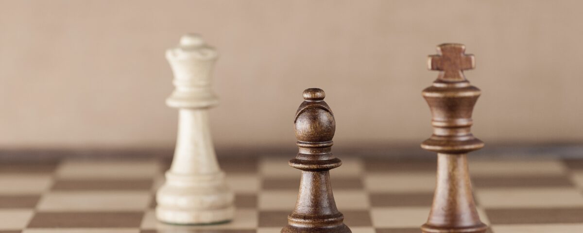 Real estate negotiation concept – chess pieces with bishop in focus, symbolizing strategy and balance.
