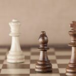 Real estate negotiation concept – chess pieces with bishop in focus, symbolizing strategy and balance.