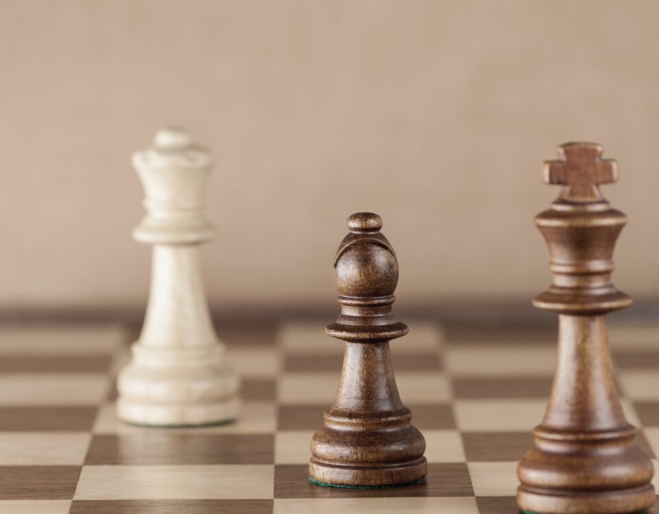 Real estate negotiation concept – chess pieces with bishop in focus, symbolizing strategy and balance.